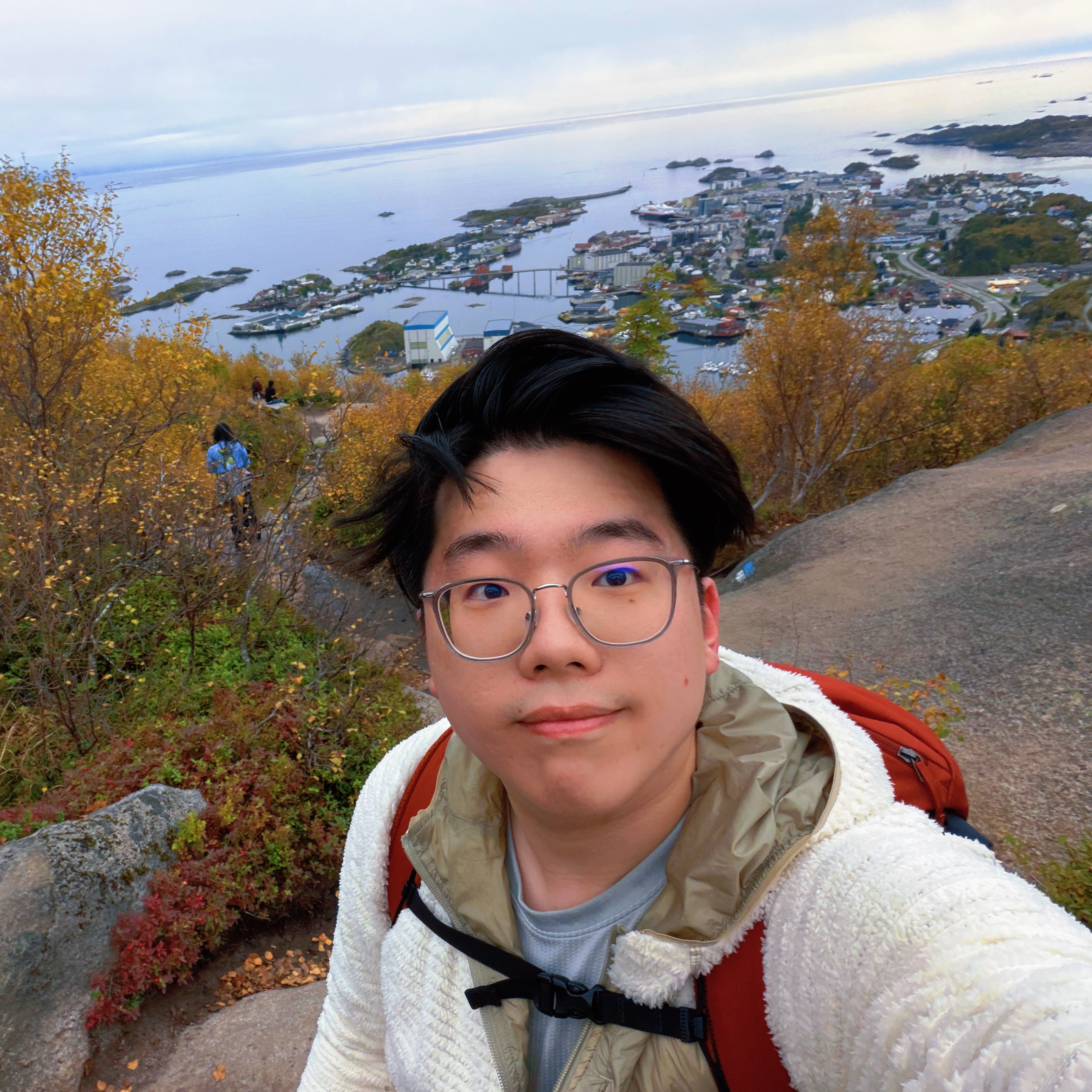 Haoming Xu outdoors overlooking a coastal town